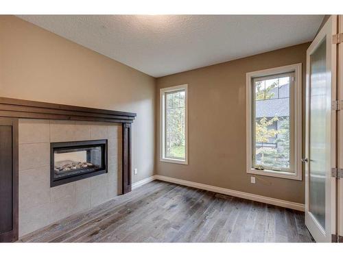 509 Hawk'S Nest Lane, Priddis Greens, AB - Indoor Photo Showing Living Room With Fireplace