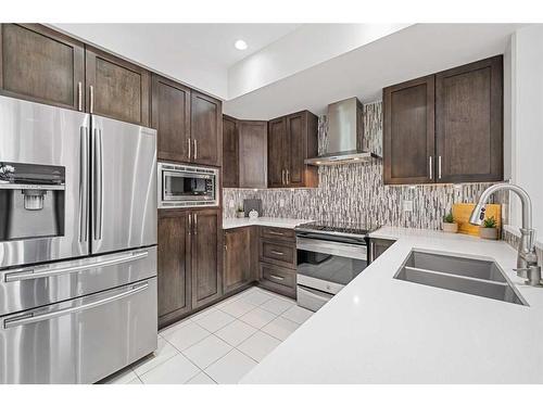 88 Cougar Ridge Landing Sw, Calgary, AB - Indoor Photo Showing Kitchen With Stainless Steel Kitchen With Double Sink With Upgraded Kitchen