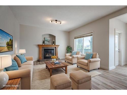 134 Coopers Bay Sw, Airdrie, AB - Indoor Photo Showing Living Room With Fireplace