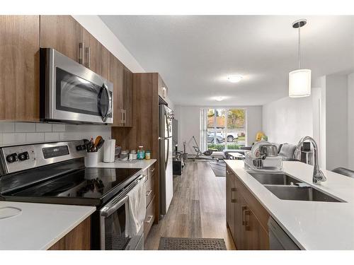 11-303 Waddy Lane, Strathmore, AB - Indoor Photo Showing Kitchen With Stainless Steel Kitchen With Double Sink