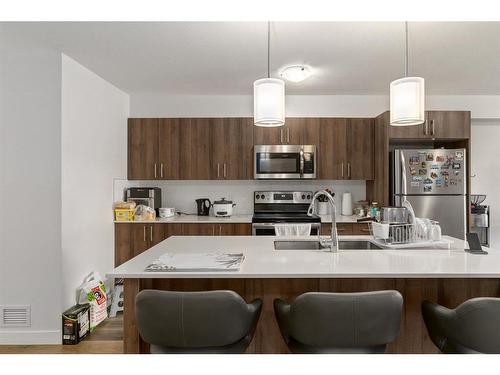 11-303 Waddy Lane, Strathmore, AB - Indoor Photo Showing Kitchen With Stainless Steel Kitchen With Double Sink With Upgraded Kitchen