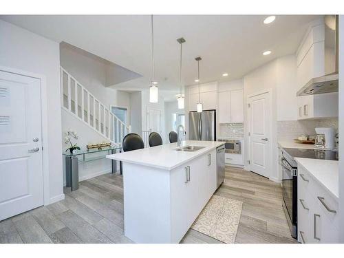 148 Magnolia Common Se, Calgary, AB - Indoor Photo Showing Kitchen With Double Sink With Upgraded Kitchen