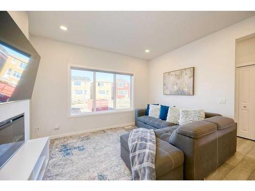 148 Magnolia Common Se, Calgary, AB - Indoor Photo Showing Living Room With Fireplace