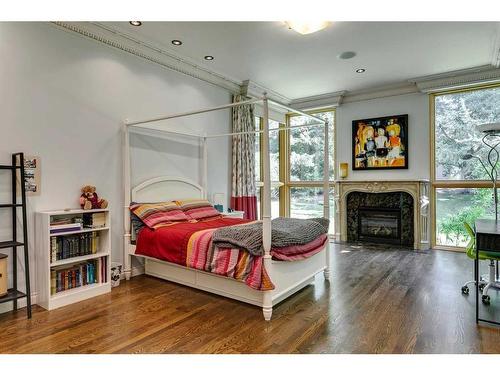 40 Eagle Ridge Place Sw, Calgary, AB - Indoor Photo Showing Bedroom With Fireplace