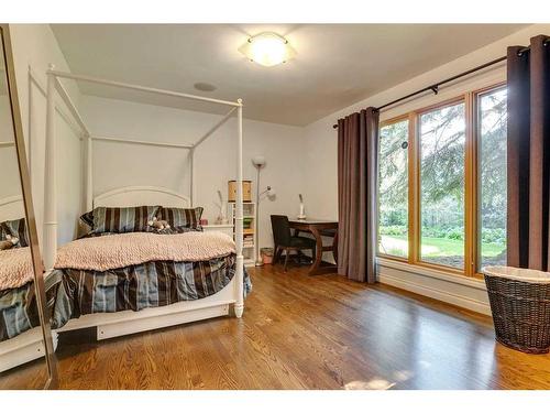 40 Eagle Ridge Place Sw, Calgary, AB - Indoor Photo Showing Bedroom With Fireplace