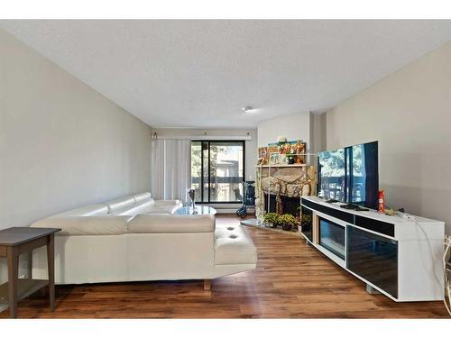 328-10120 Brookpark Boulevard Sw, Calgary, AB - Indoor Photo Showing Living Room With Fireplace