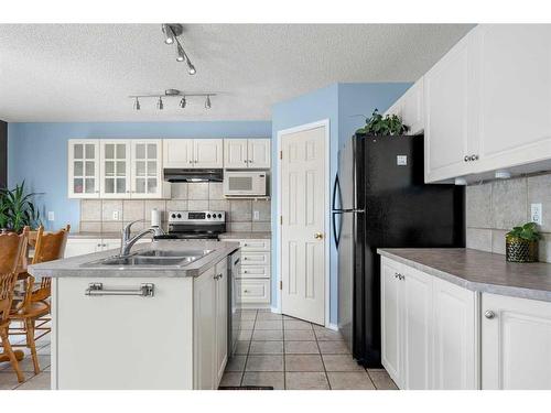 44 Crystalridge Close, Okotoks, AB - Indoor Photo Showing Kitchen With Double Sink