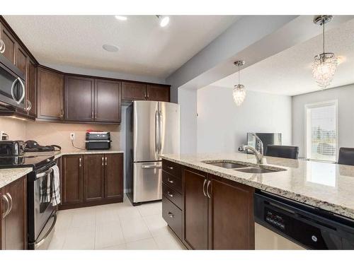 324 Windstone Gardens Sw, Airdrie, AB - Indoor Photo Showing Kitchen With Stainless Steel Kitchen With Double Sink