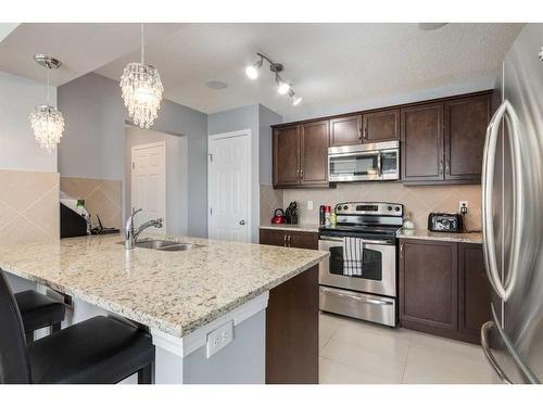 324 Windstone Gardens Sw, Airdrie, AB - Indoor Photo Showing Kitchen With Stainless Steel Kitchen With Double Sink With Upgraded Kitchen