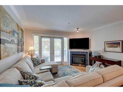 102-630 10 Street Nw, Calgary, AB - Indoor Photo Showing Living Room With Fireplace