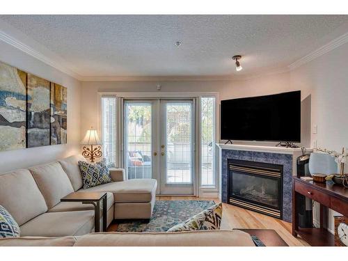 102-630 10 Street Nw, Calgary, AB - Indoor Photo Showing Living Room With Fireplace