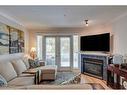 102-630 10 Street Nw, Calgary, AB  - Indoor Photo Showing Living Room With Fireplace 