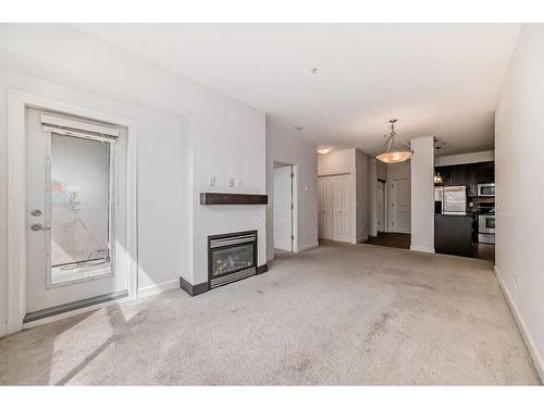 201-88 Arbour Lake Road Nw, Calgary, AB - Indoor Photo Showing Other Room With Fireplace