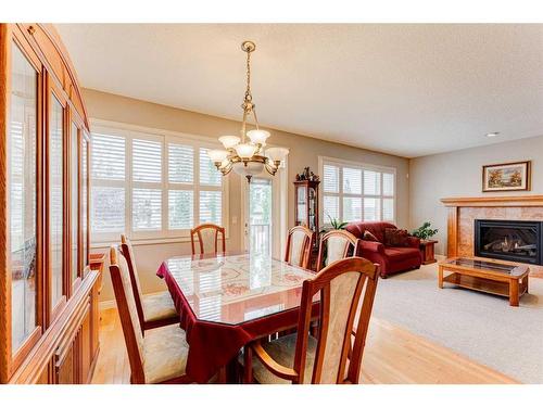 109 Panamount Road Nw, Calgary, AB - Indoor Photo Showing Dining Room With Fireplace