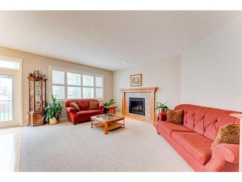 109 Panamount Road Nw, Calgary, AB - Indoor Photo Showing Living Room With Fireplace