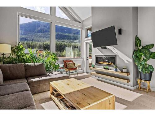 502-105 Stewart Creek Rise, Canmore, AB - Indoor Photo Showing Living Room With Fireplace