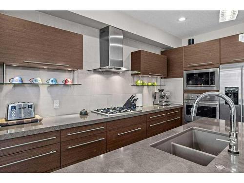 502-105 Stewart Creek Rise, Canmore, AB - Indoor Photo Showing Kitchen With Double Sink With Upgraded Kitchen