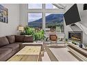 502-105 Stewart Creek Rise, Canmore, AB  - Indoor Photo Showing Living Room With Fireplace 