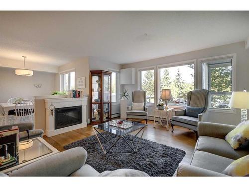 128-7229 Sierra Morena Boulevard Sw, Calgary, AB - Indoor Photo Showing Living Room With Fireplace