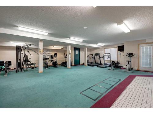 128-7229 Sierra Morena Boulevard Sw, Calgary, AB - Indoor Photo Showing Gym Room