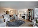 128-7229 Sierra Morena Boulevard Sw, Calgary, AB  - Indoor Photo Showing Living Room With Fireplace 