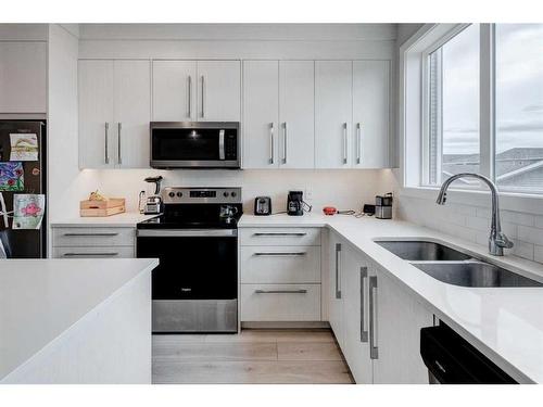 232 Chelsea Manor, Chestermere, AB - Indoor Photo Showing Kitchen With Double Sink With Upgraded Kitchen