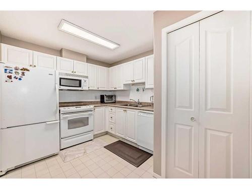 413-5000 Somervale Court Sw, Calgary, AB - Indoor Photo Showing Kitchen With Double Sink