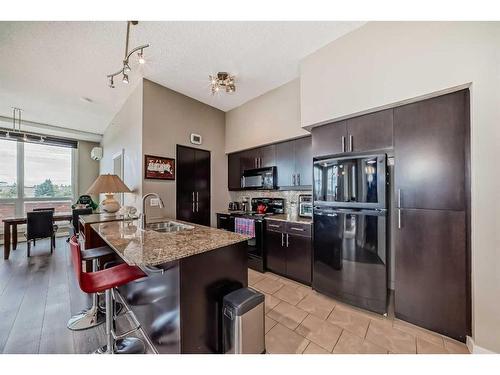 320-8710 Horton Road Sw, Calgary, AB - Indoor Photo Showing Kitchen With Double Sink With Upgraded Kitchen