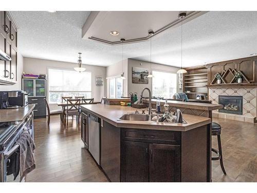 7 Pantego Rise Nw, Calgary, AB - Indoor Photo Showing Kitchen With Fireplace