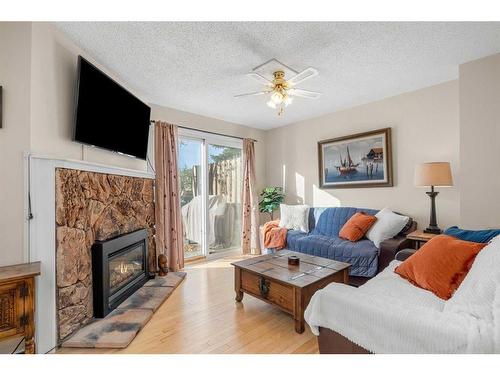 72-4940 39 Avenue Sw, Calgary, AB - Indoor Photo Showing Living Room With Fireplace