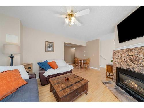 72-4940 39 Avenue Sw, Calgary, AB - Indoor Photo Showing Living Room With Fireplace