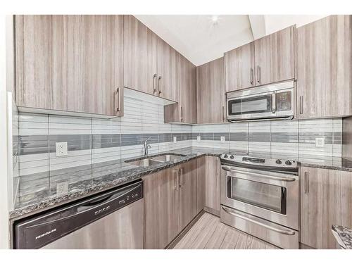 208-8 Sage Hill Terrace Nw, Calgary, AB - Indoor Photo Showing Kitchen With Stainless Steel Kitchen With Double Sink With Upgraded Kitchen