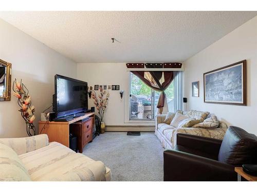 104-525 56 Avenue Sw, Calgary, AB - Indoor Photo Showing Living Room