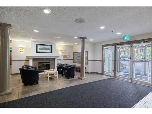 104-525 56 Avenue Sw, Calgary, AB - Indoor With Fireplace