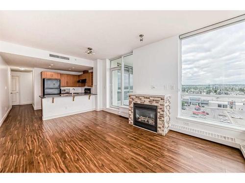 907-55 Spruce Place Sw, Calgary, AB - Indoor With Fireplace