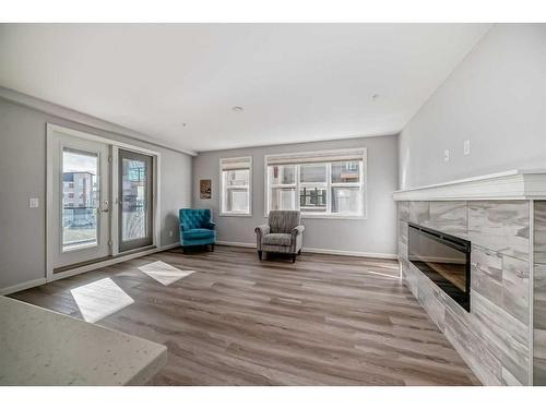 1310-10 Market Boulevard Se, Airdrie, AB - Indoor Photo Showing Living Room With Fireplace