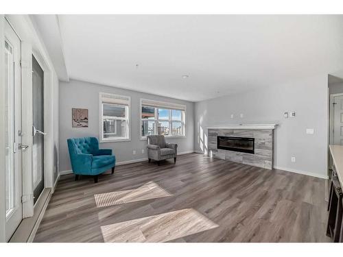 1310-10 Market Boulevard Se, Airdrie, AB - Indoor Photo Showing Living Room With Fireplace