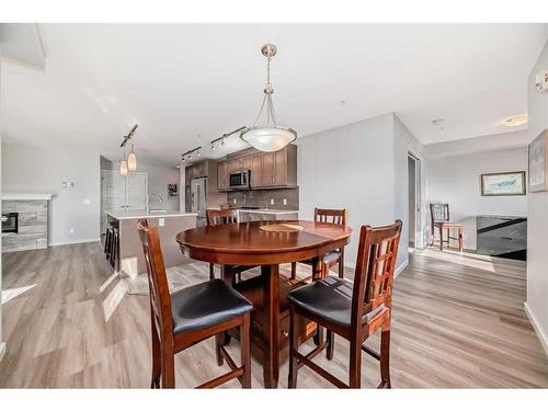 1310-10 Market Boulevard Se, Airdrie, AB - Indoor Photo Showing Dining Room With Fireplace