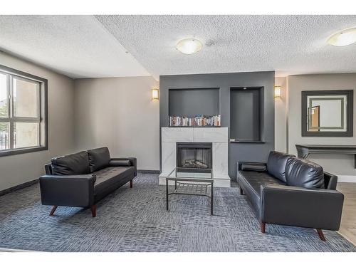 4306-73 Erin Woods Court Se, Calgary, AB - Indoor Photo Showing Living Room With Fireplace