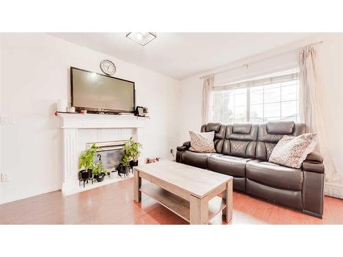 110 Taravista Drive Ne, Calgary, AB - Indoor Photo Showing Living Room With Fireplace