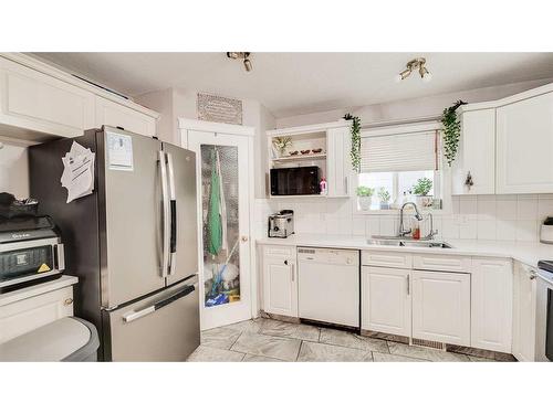 110 Taravista Drive Ne, Calgary, AB - Indoor Photo Showing Kitchen With Double Sink