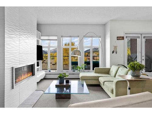 403-1151 Sidney Street, Canmore, AB - Indoor Photo Showing Living Room With Fireplace