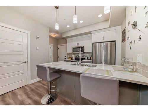 102-19661 40 Street Se, Calgary, AB - Indoor Photo Showing Kitchen With Double Sink With Upgraded Kitchen