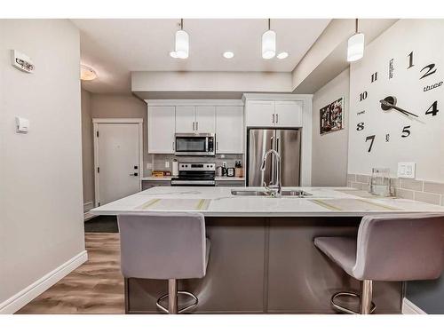 102-19661 40 Street Se, Calgary, AB - Indoor Photo Showing Kitchen With Upgraded Kitchen