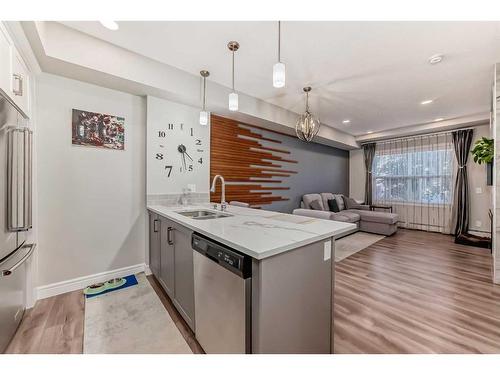 102-19661 40 Street Se, Calgary, AB - Indoor Photo Showing Kitchen With Double Sink With Upgraded Kitchen