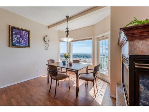 363 Rocky Ridge Drive Nw, Calgary, AB - Indoor Photo Showing Dining Room With Fireplace