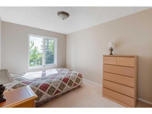 363 Rocky Ridge Drive Nw, Calgary, AB - Indoor Photo Showing Bedroom