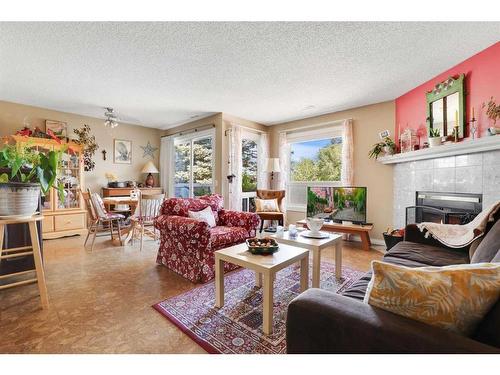 43-200 Shawnessy Drive Sw, Calgary, AB - Indoor Photo Showing Living Room With Fireplace