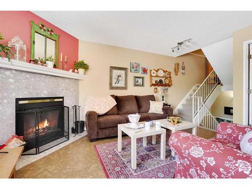 43-200 Shawnessy Drive Sw, Calgary, AB - Indoor Photo Showing Living Room With Fireplace