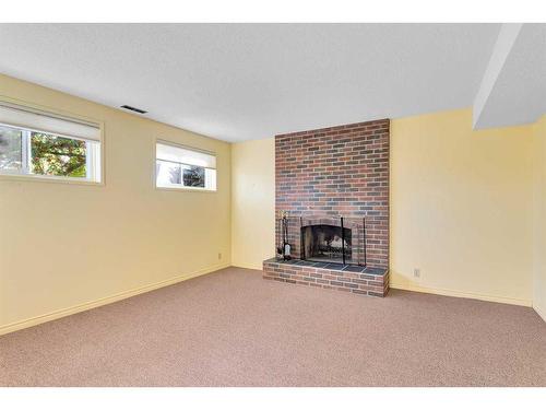 36 Silver Ridge Rise Nw, Calgary, AB - Indoor Photo Showing Living Room With Fireplace